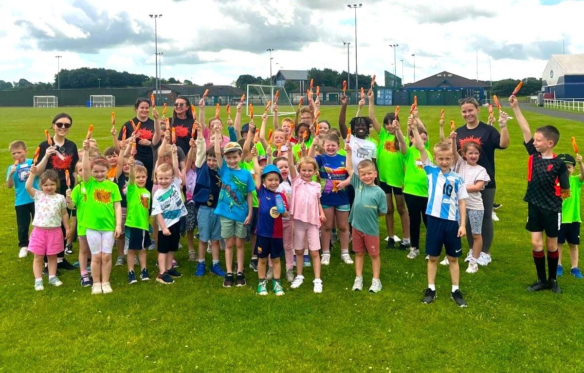 Children cheering at a holiday camp